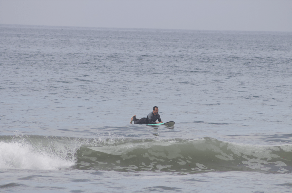 A surf instructor waits for the perfect wave to ride April 18. Students said they enjoyed lessons with a Makos' trained professional. Photo by Karla Suzuki